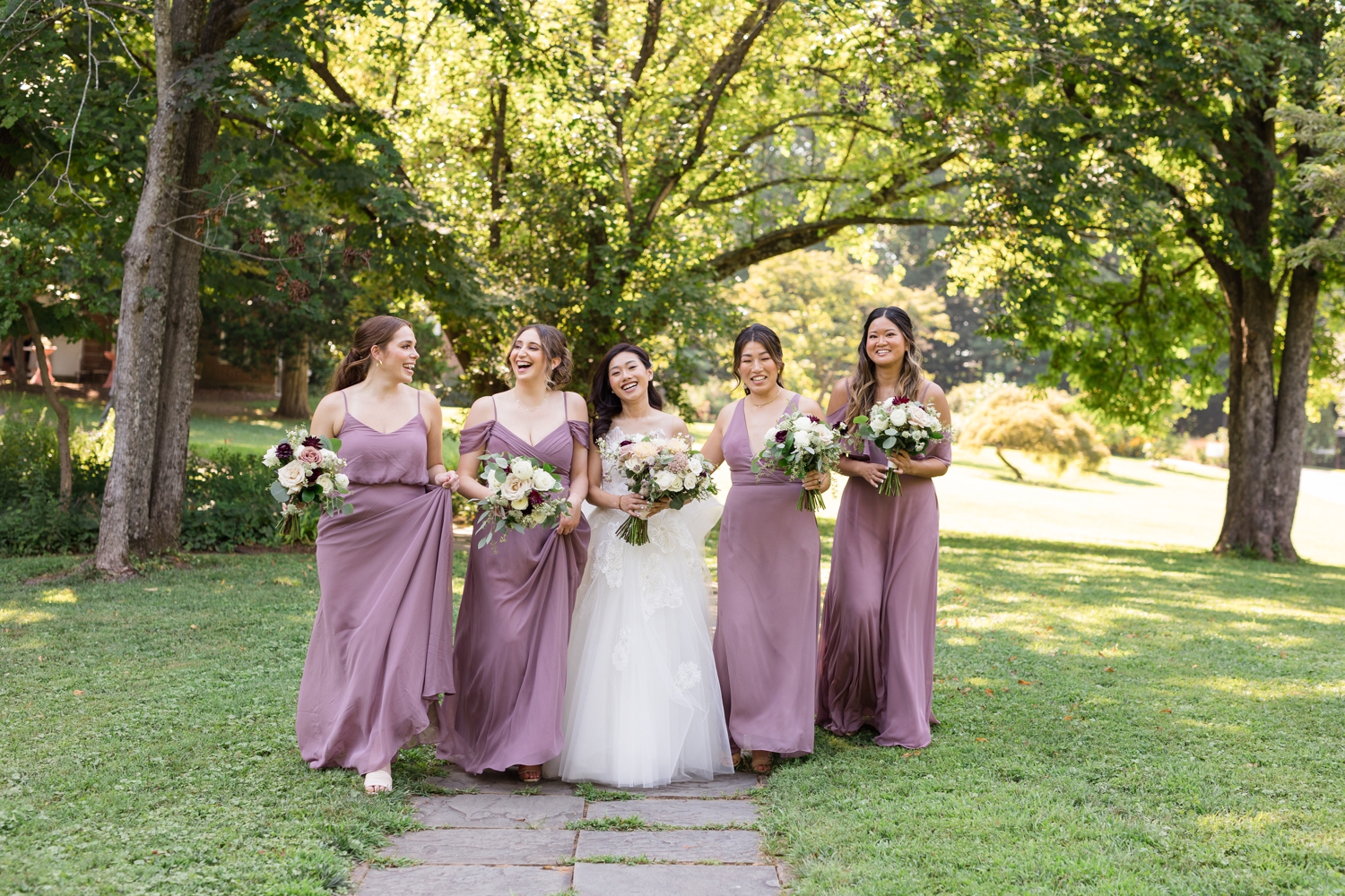 bride and bridesmaids walk the grounds at Woodend Sanctuary & Mansion 