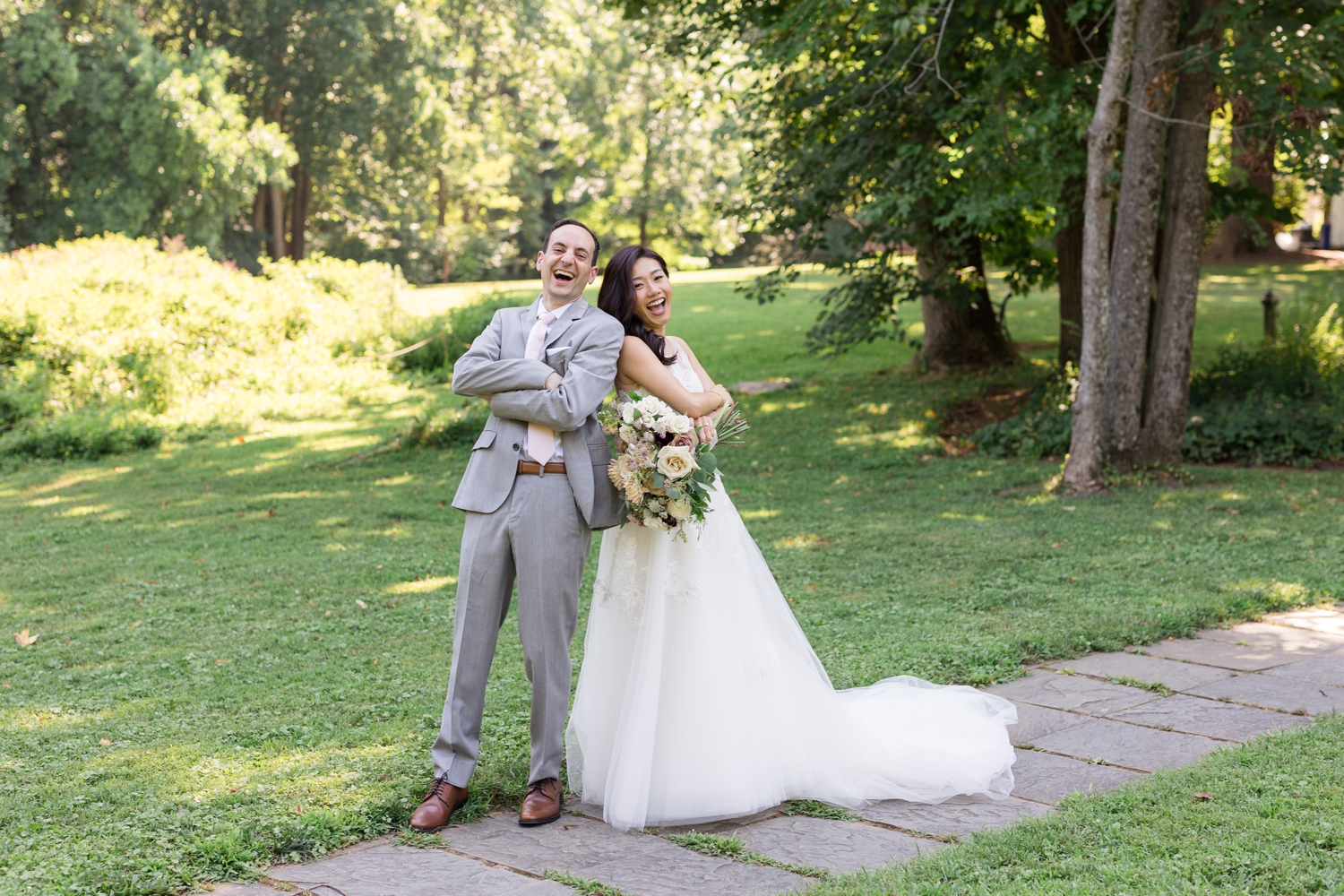 bride and groom laugh on the grounds at Woodend Sanctuary & Mansion 