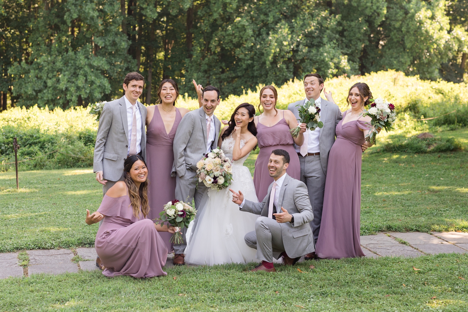 bridal party poses together on the grounds at Woodend Sanctuary & Mansion 