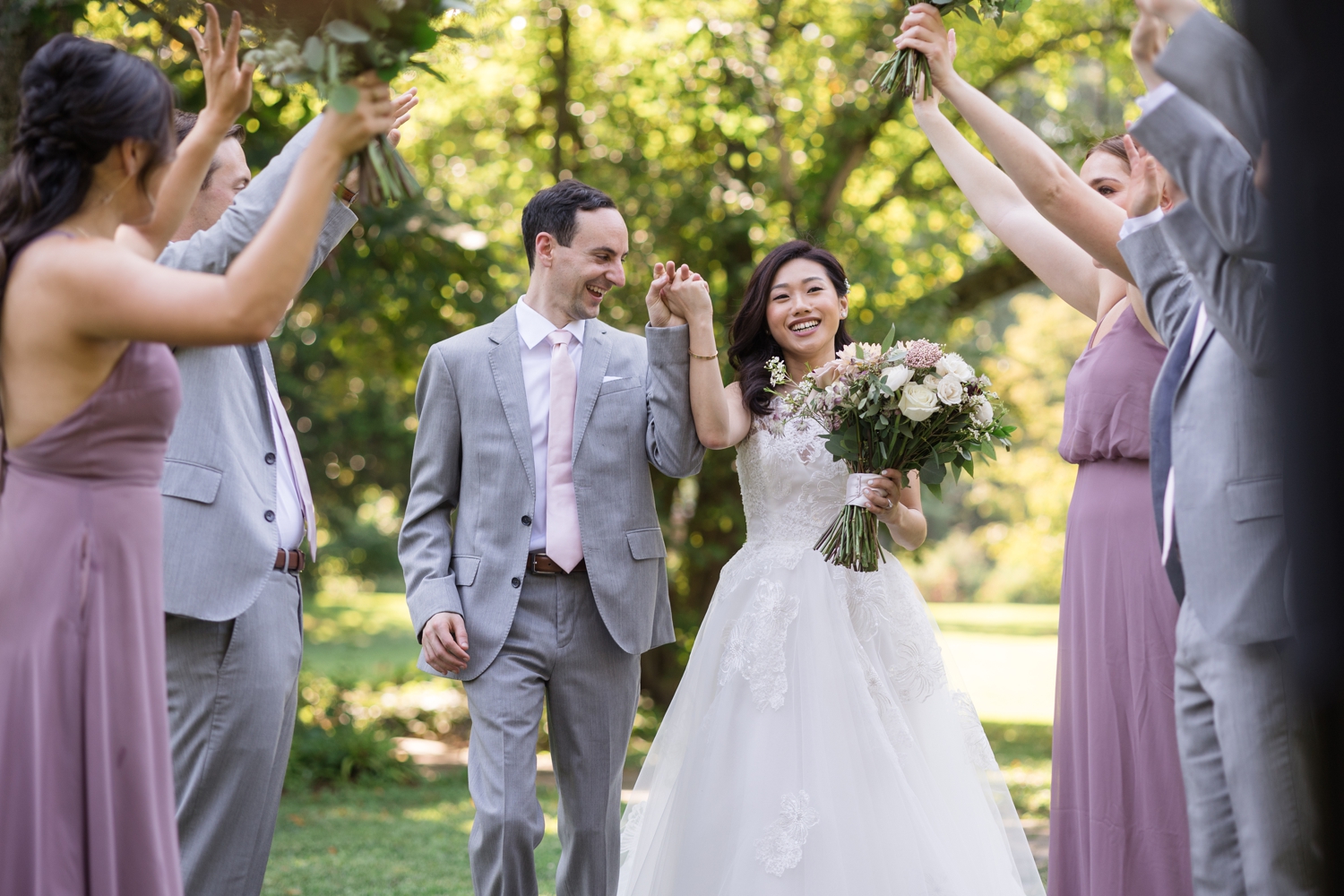 bride and groom laugh surrounded by bridal party Woodend Sanctuary & Mansion 