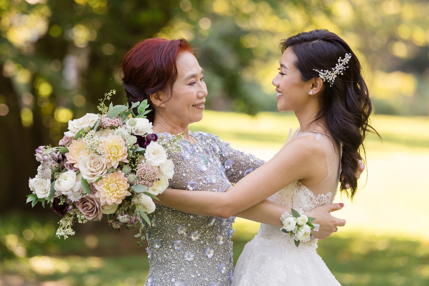 bride hugs her mother on the grounds at Woodend Sanctuary & Mansion 