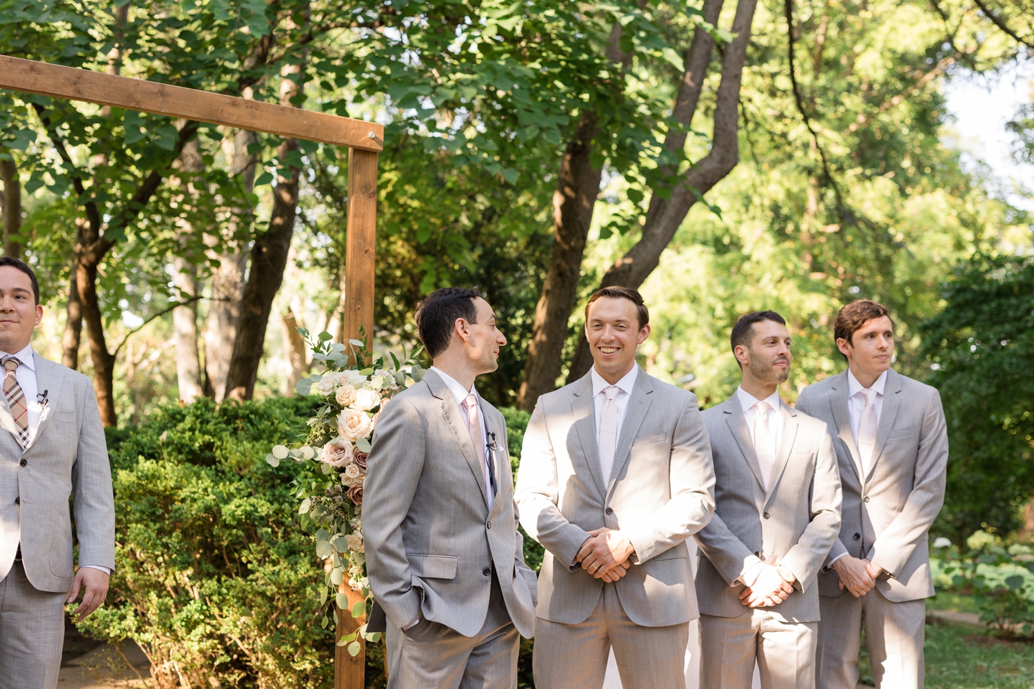 groomsmen react to bride's entrance on the grounds at Woodend Sanctuary & Mansion 