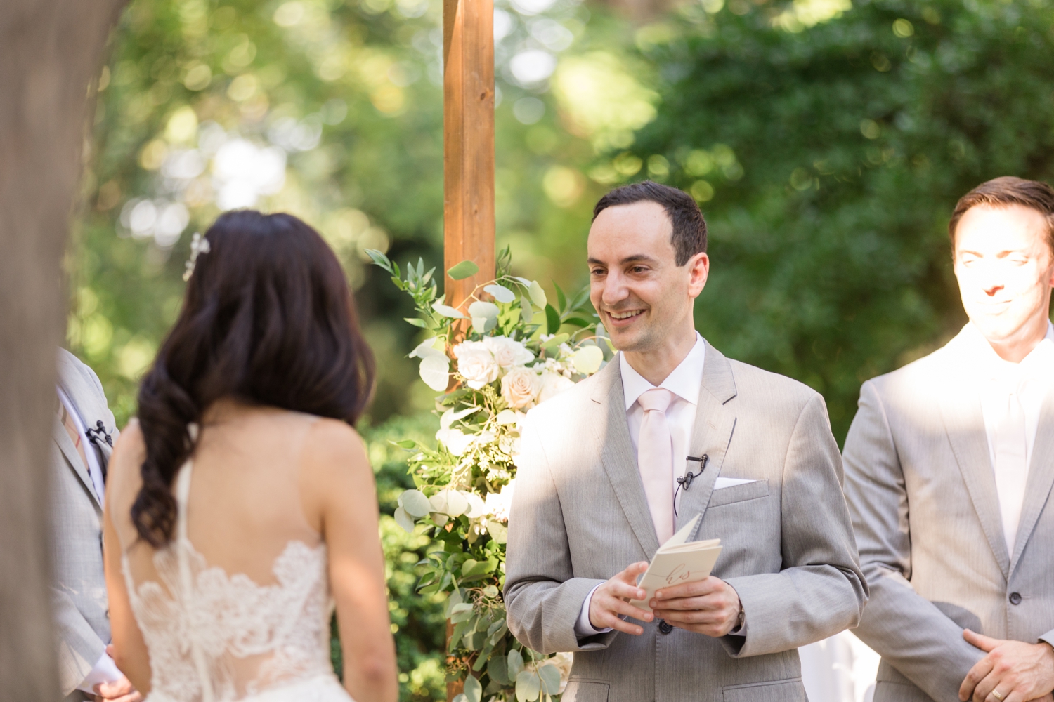 grooms shares vows with bride during ceremony at Woodend Sanctuary & Mansion 