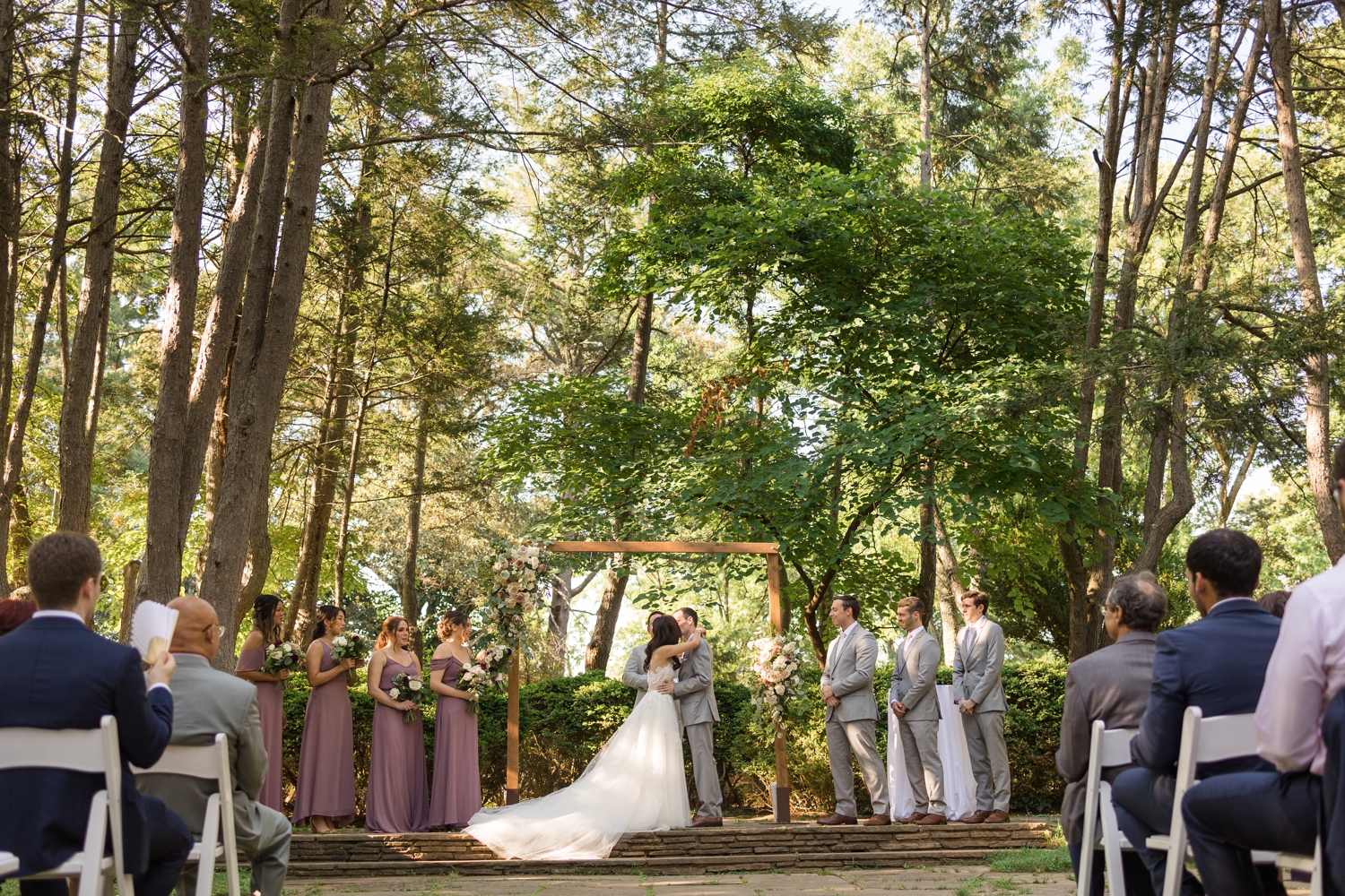 bride and groom share first kiss at Woodend Sanctuary & Mansion 