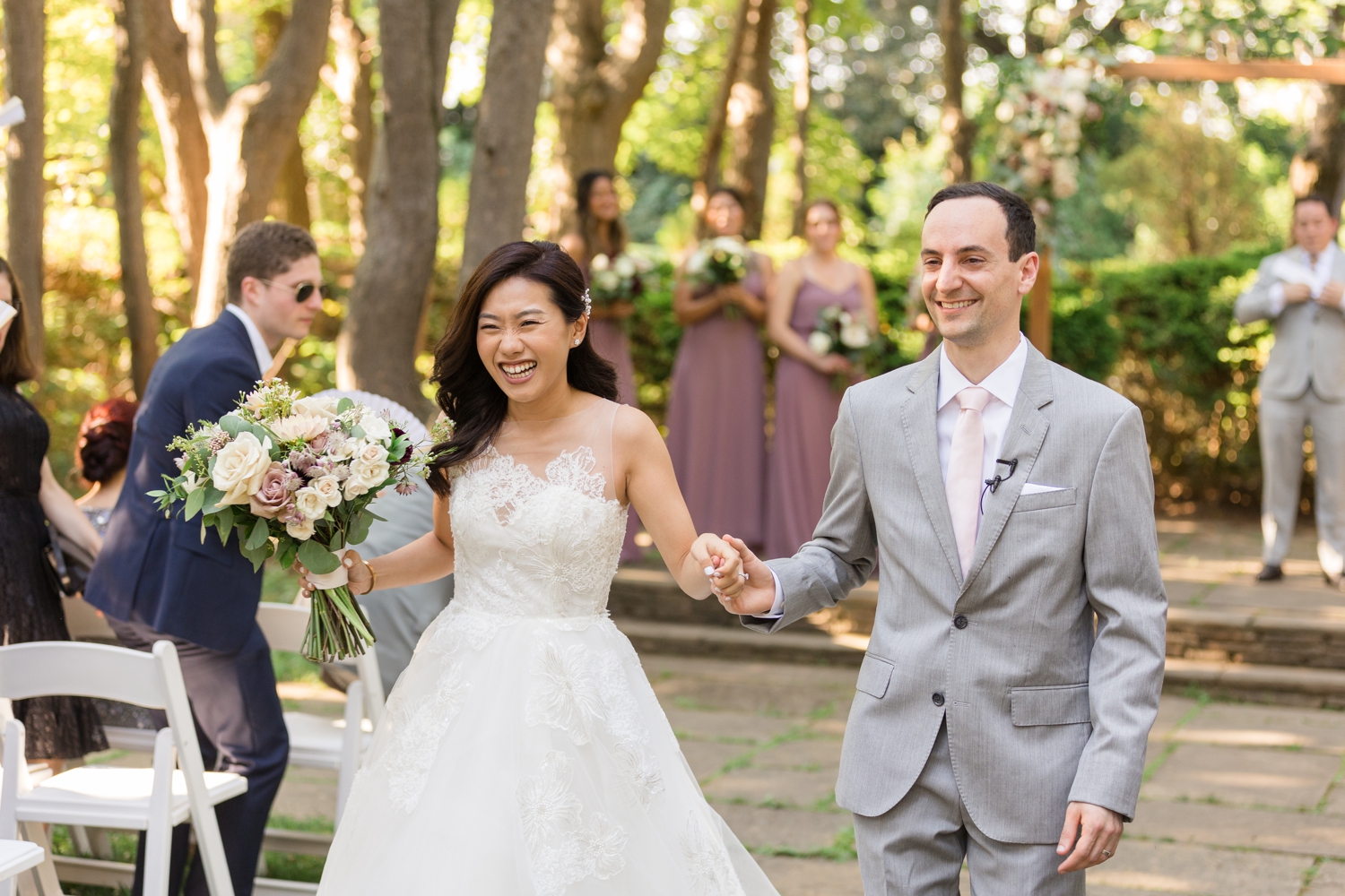 bride and groom smile as they exit their ceremony at Woodend Sanctuary & Mansion 