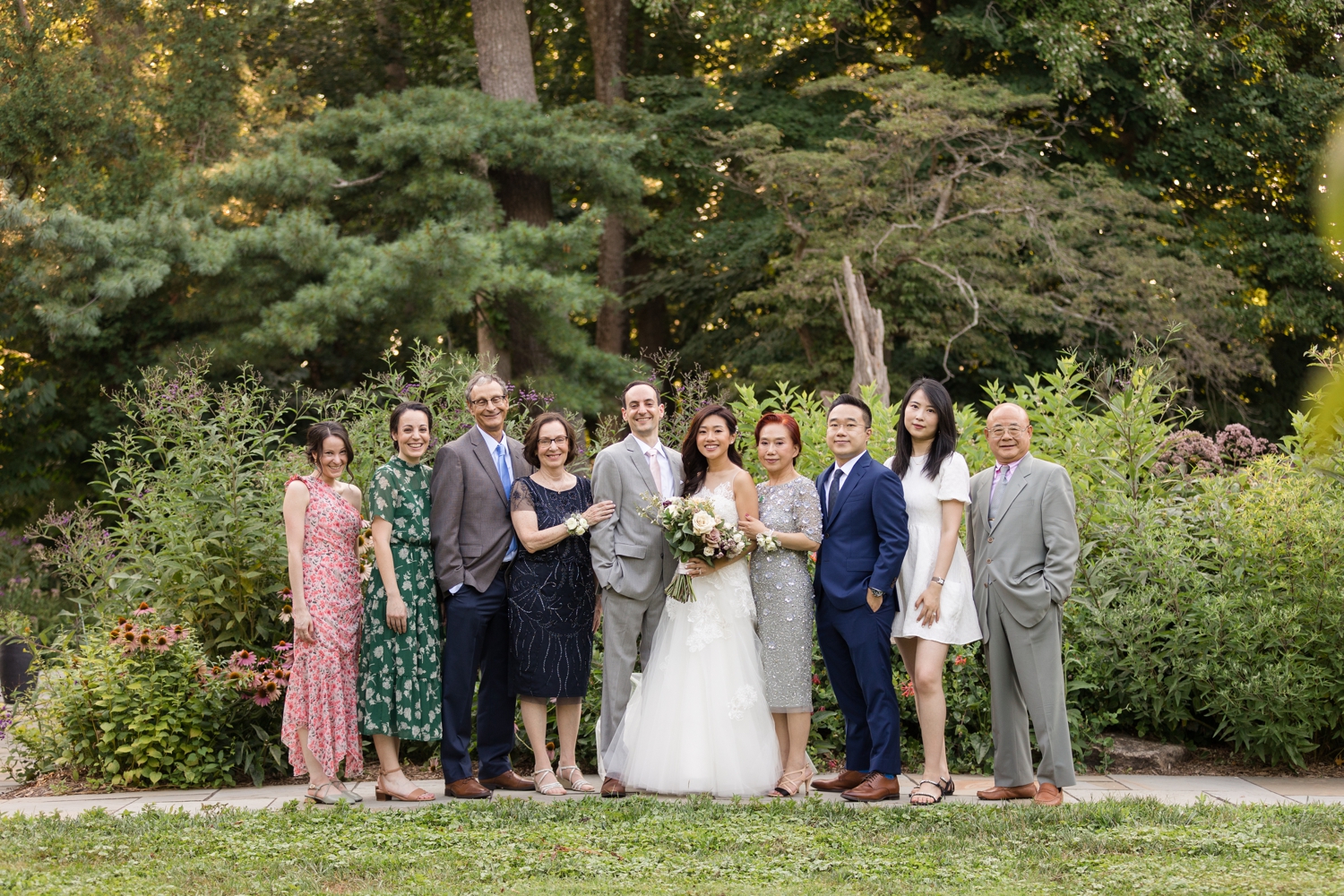 bride and groom pose for family formals on the grounds at Summer Woodend Sanctuary & Mansion 