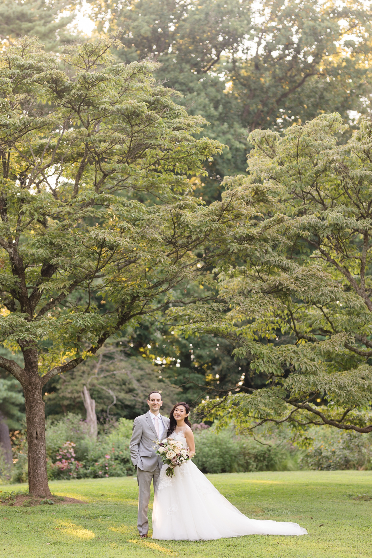 bride and groom pose on the grounds at Woodend Sanctuary & Mansion 