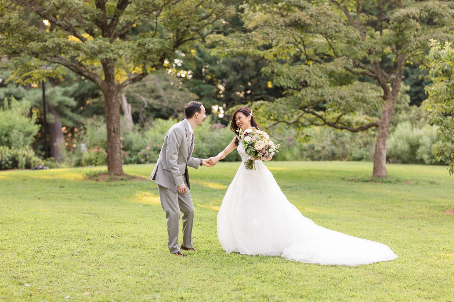 bride and groom share a laugh on the grounds at Woodend Sanctuary & Mansion 