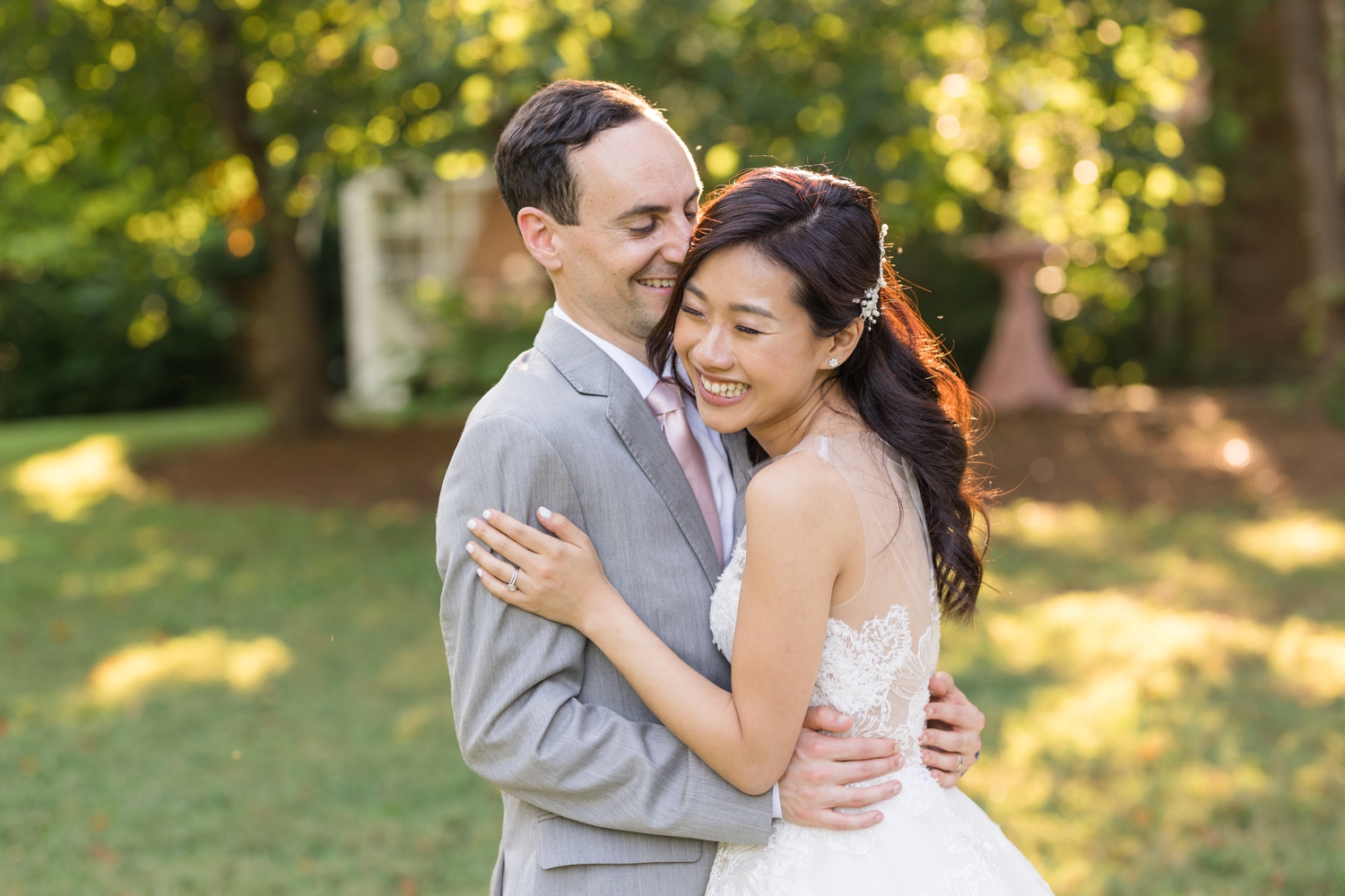 bride and groom laugh together on the grounds at Woodend Sanctuary & Mansion 