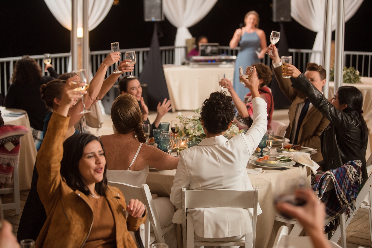 Chesapeake Bay Foundation tented reception wedding toasts two brides