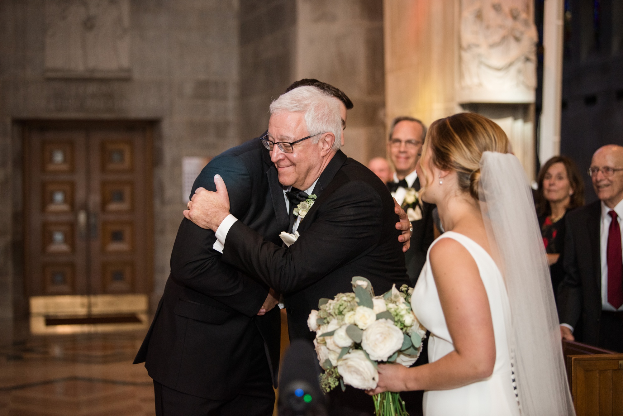 Cathedral of Mary our Queen wedding ceremony groom hugging father of the bride