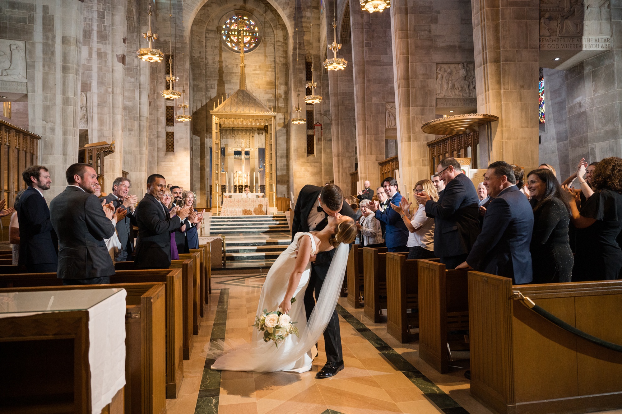 Cathedral of Mary our Queen wedding ceremony couple dipping in the aisle