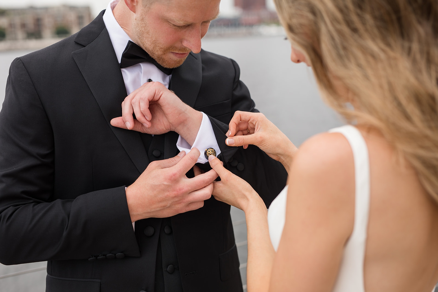 Baltimore harbor first look with bride and groom in black tux