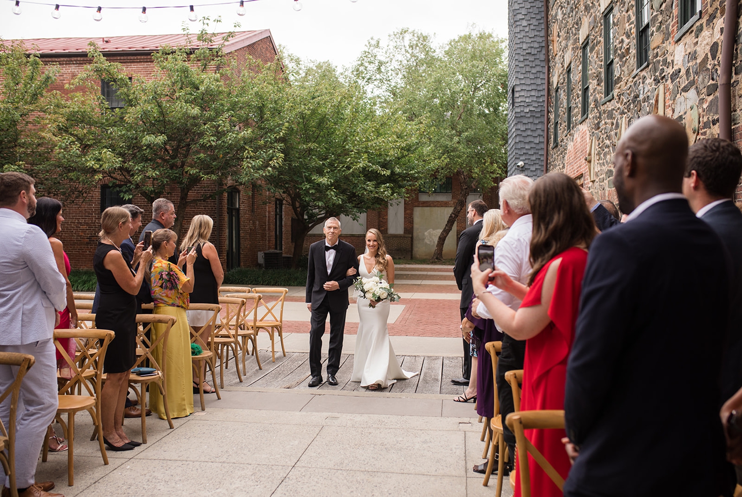 Mt Washington Mill Dye House Bride in BHLDN walking down the ceremony aisle