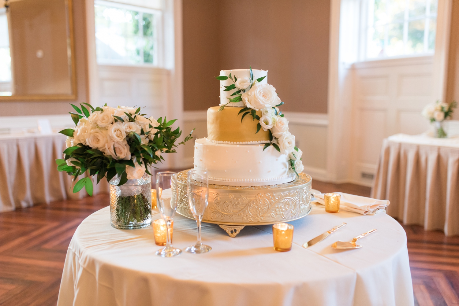 gold and white wedding cake at Tidewater Inn Gold Room