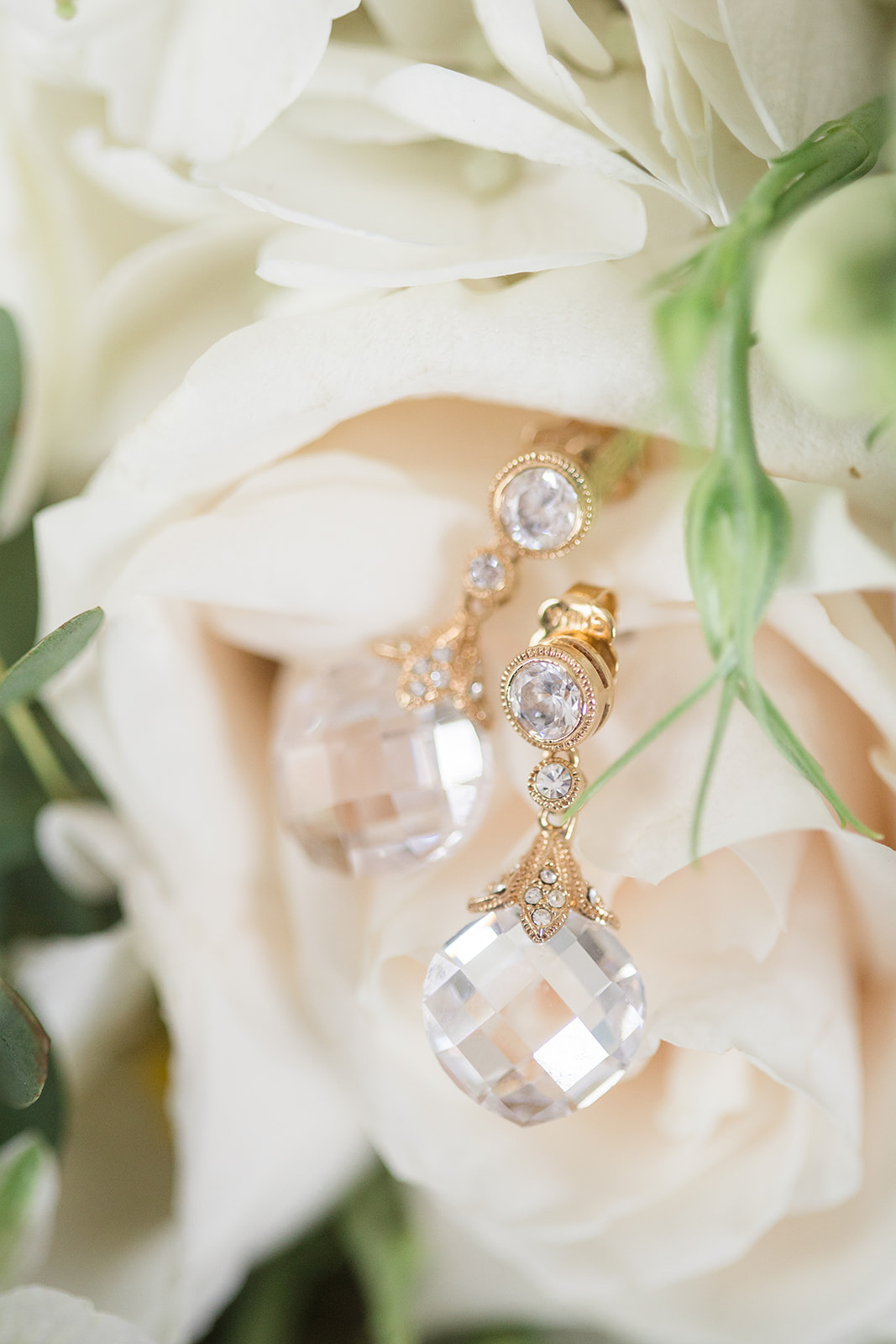 Bridal earrings close up nested into bridal bouquet