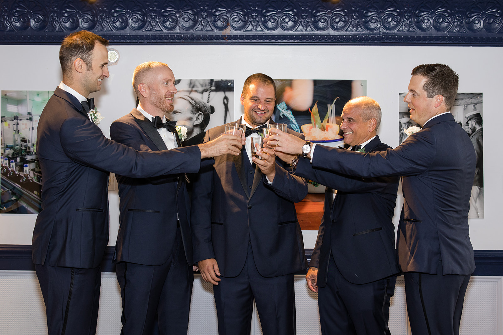 Groom cheersing with his groomsmen