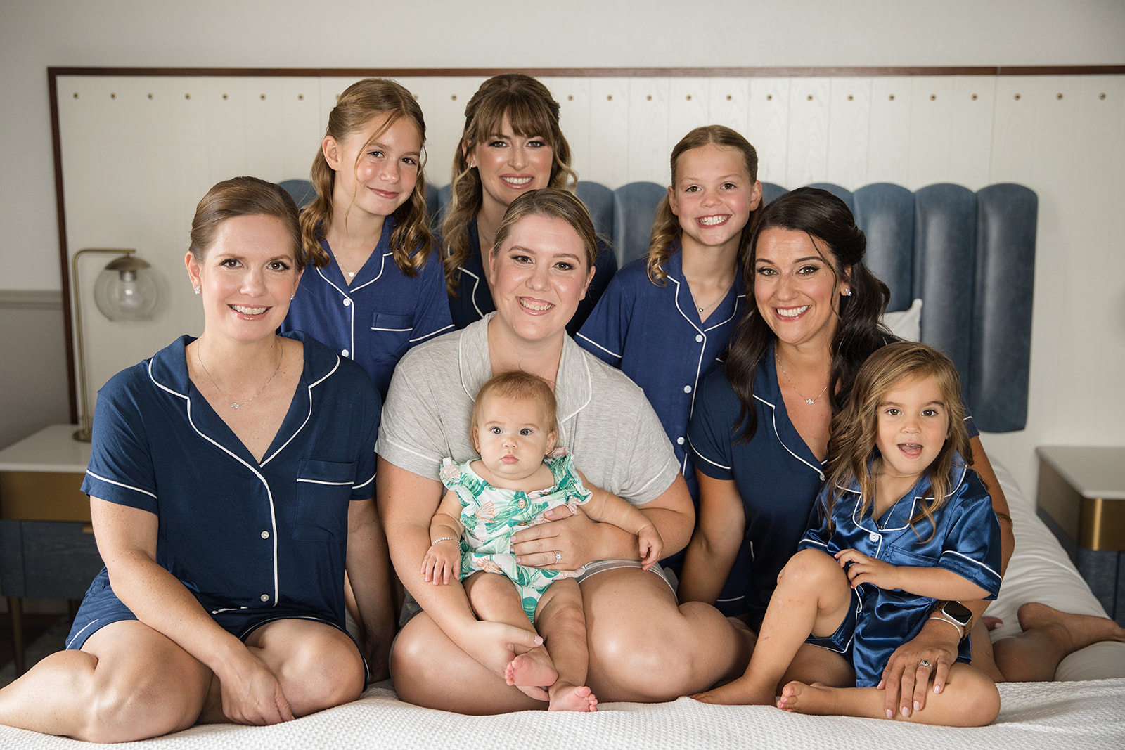 Bride and her bridal party in pajamas on the bed