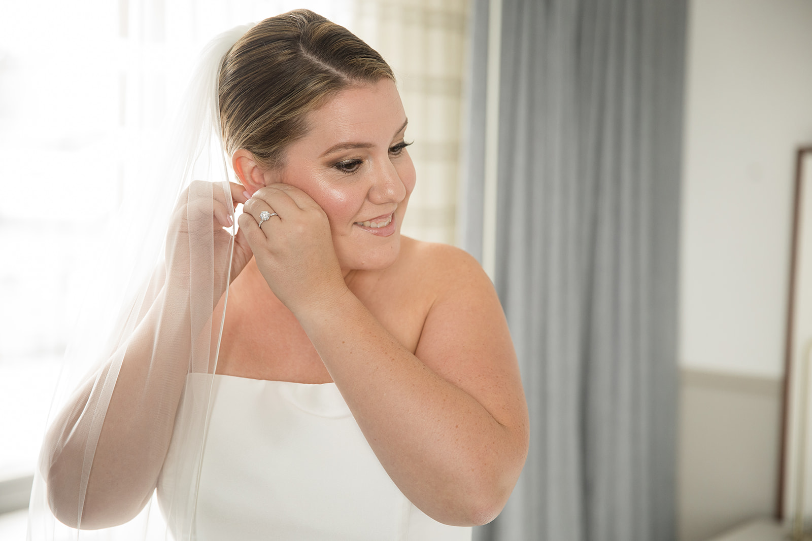 Bride puts in earrings