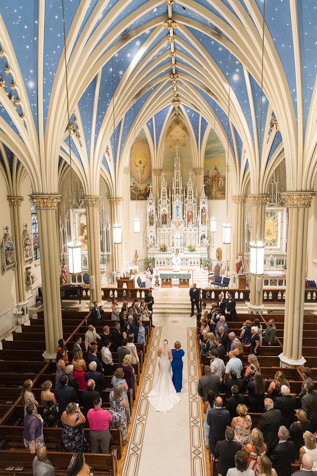 wide shot of St. Mary's church, bride coming down the aisle