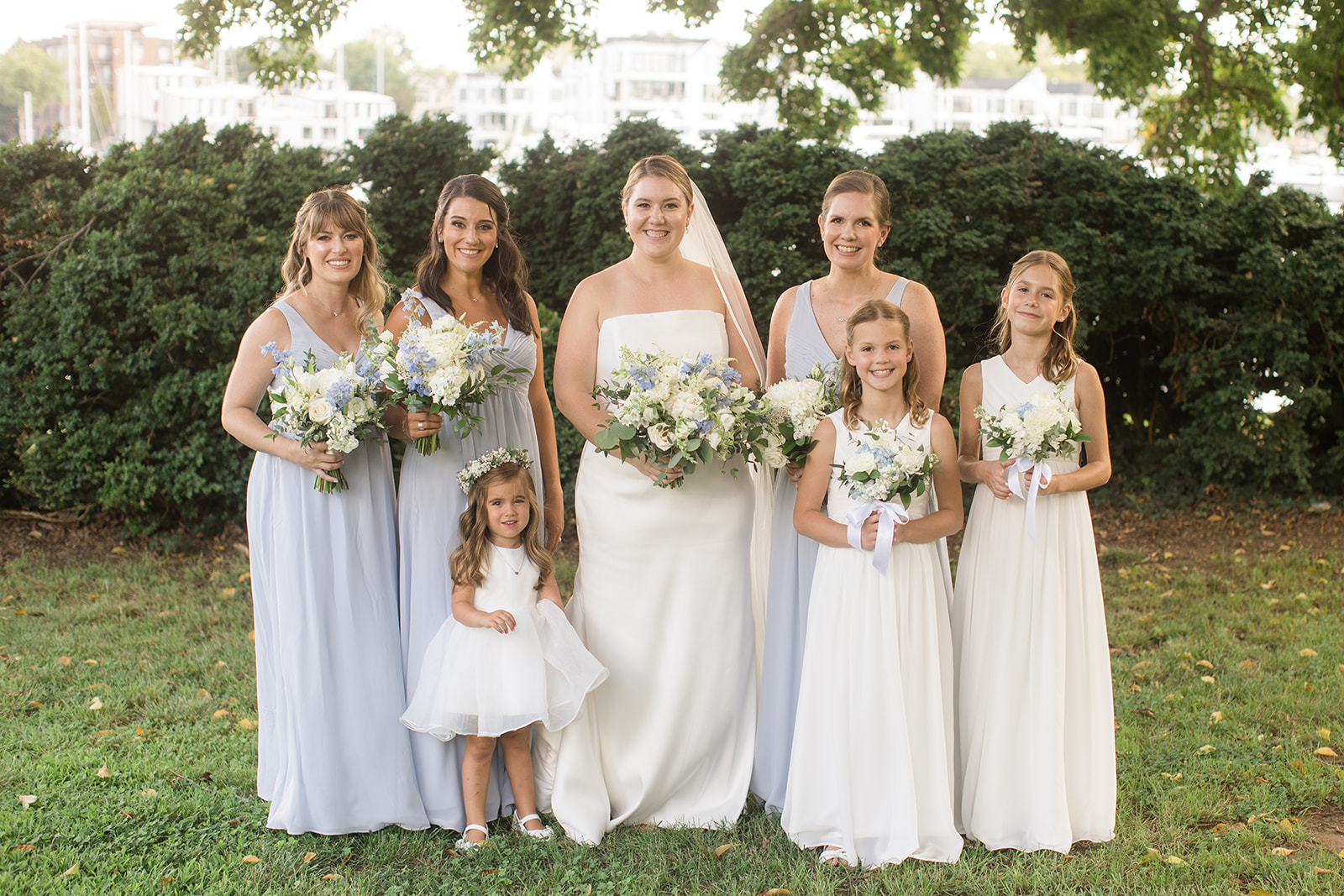 bridal party portrait with bride, bridesmaids, and flower girls