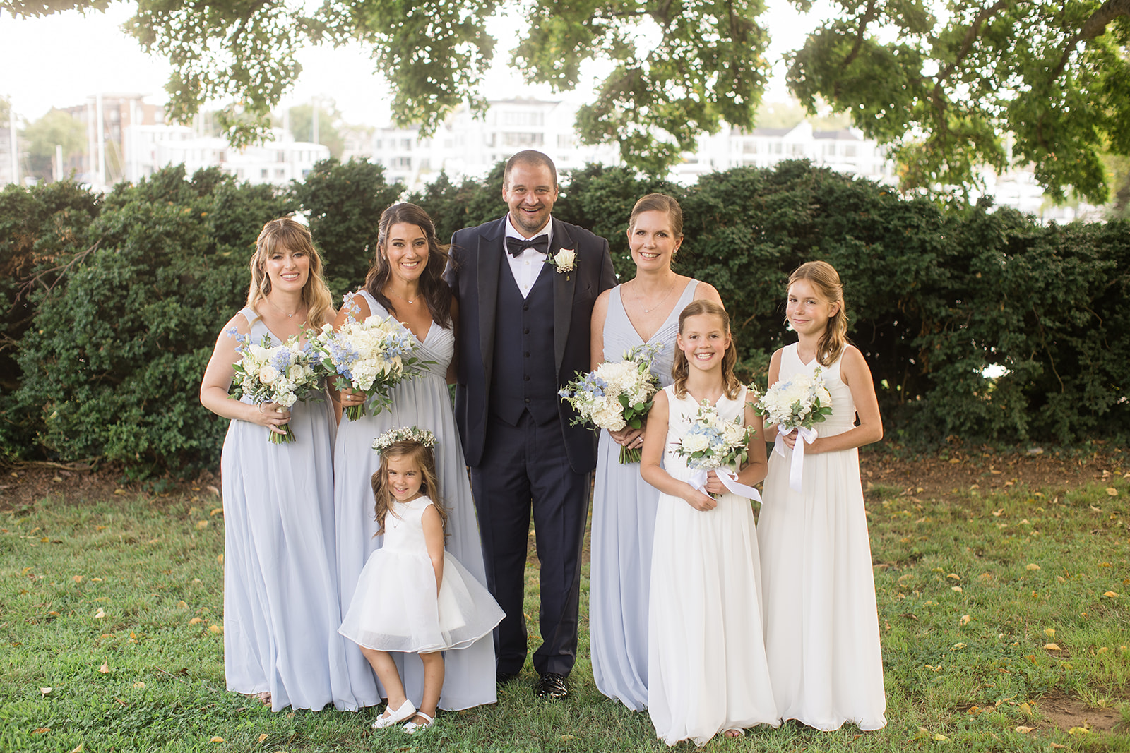 bridal party portrait with bride, groom, bridesmaids, and flower girls