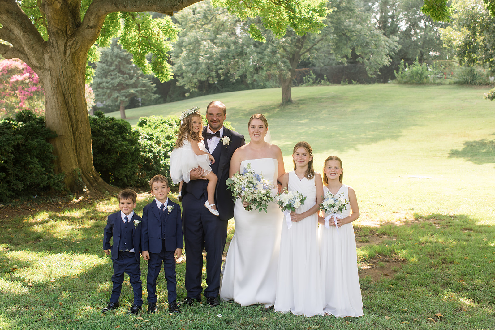 bride and groom with young kids in wedding party