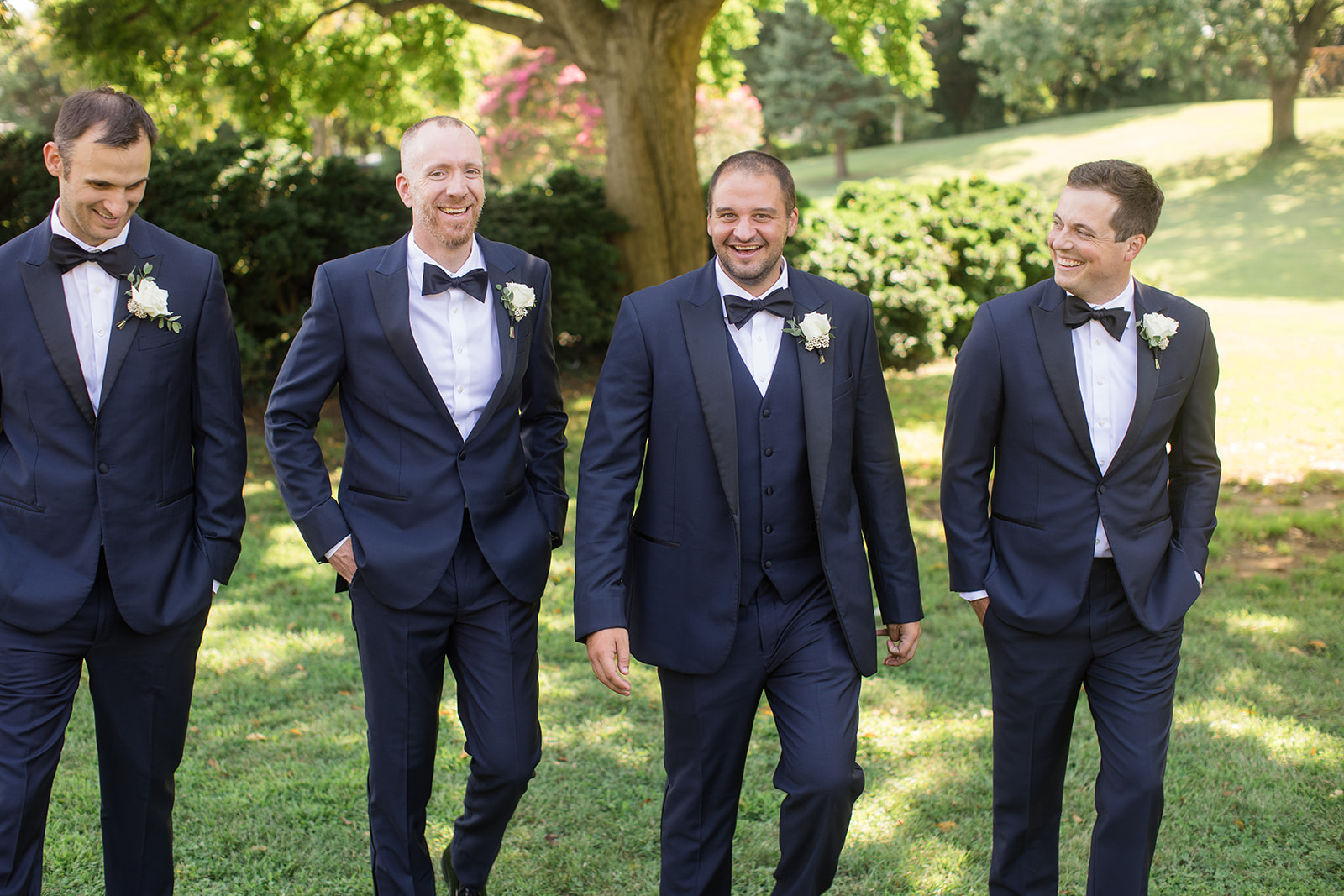 groom with groomsmen in garden walking