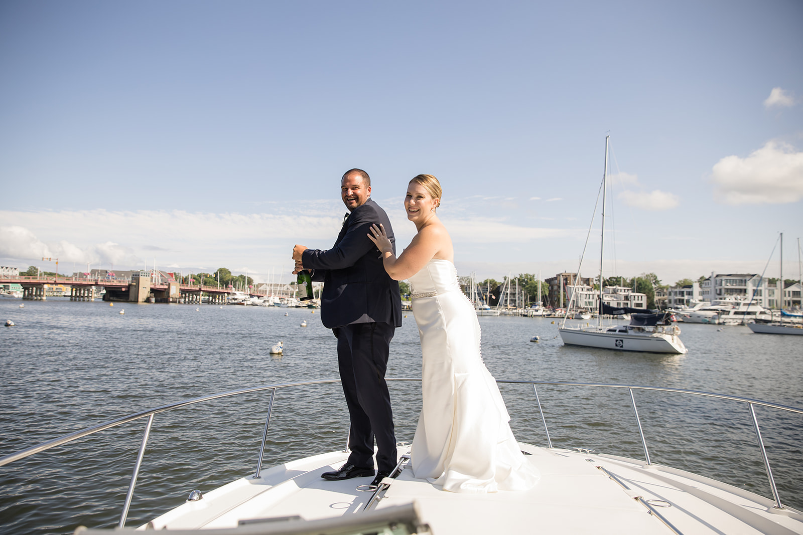 bride and groom on bow of boat in Ego Alley