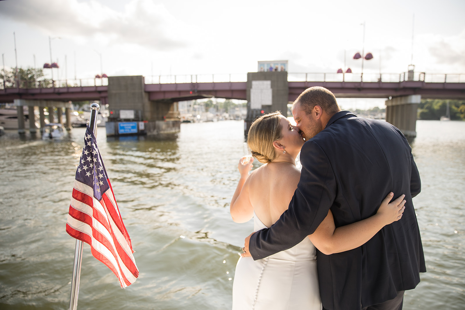 bride and groom kissing on boat