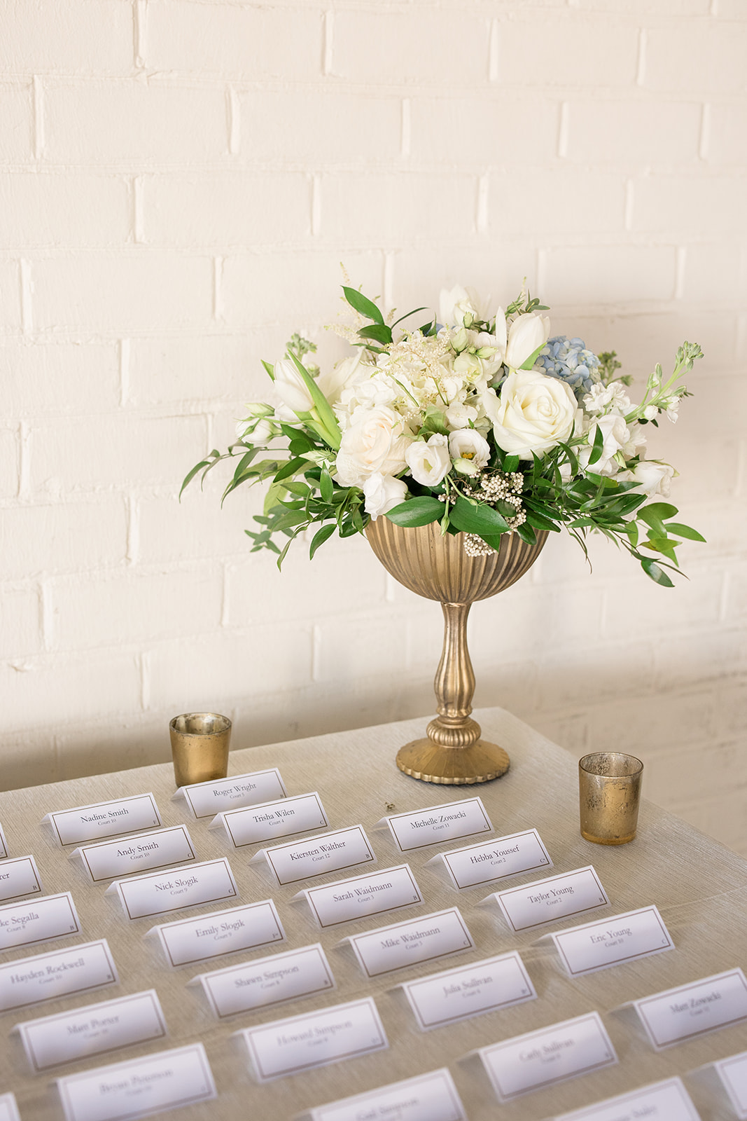 wedding escort card display with floral arrangement