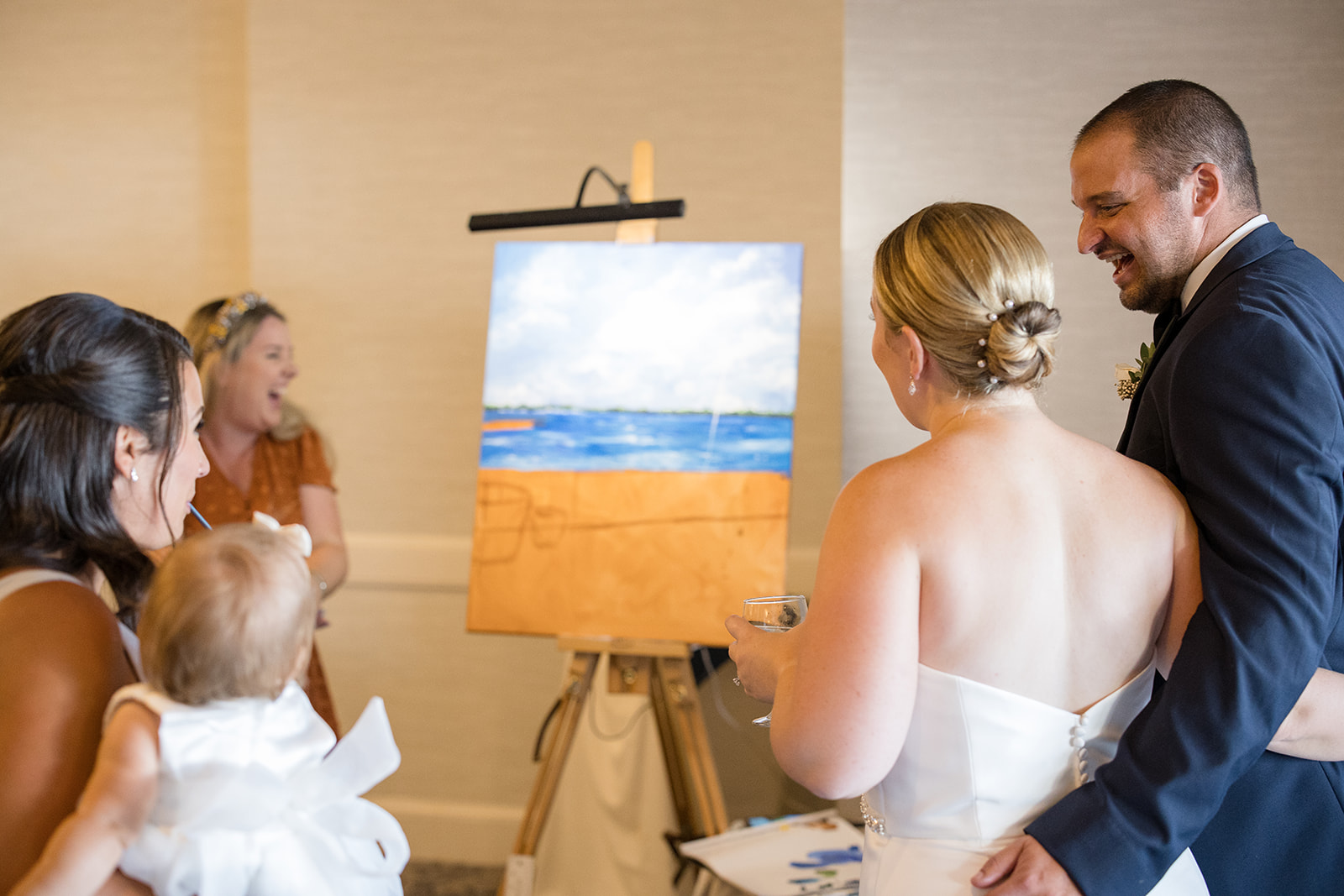 bride and groom look at live wedding painter