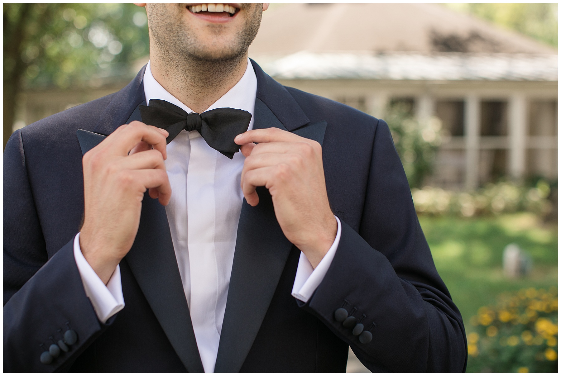 groom adjusting bowtie