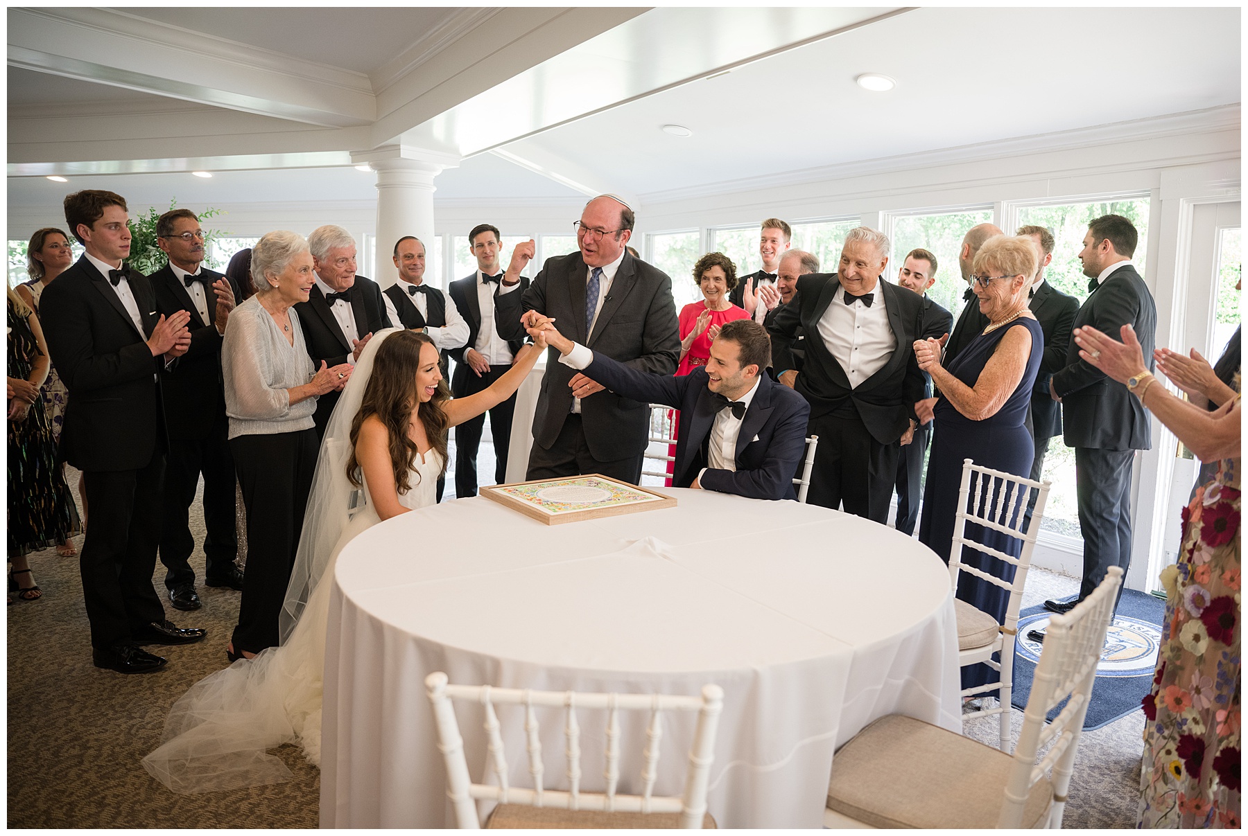 bride and groom sign ketubah