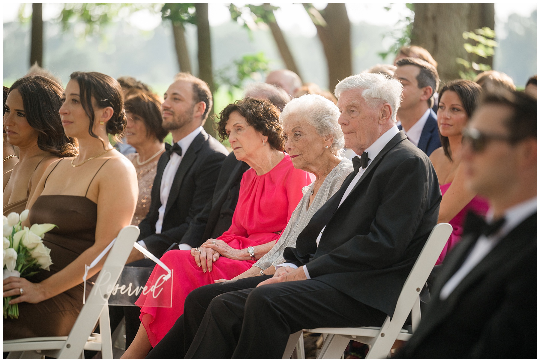 family seated for wedding ceremony outdoors at kent island resort