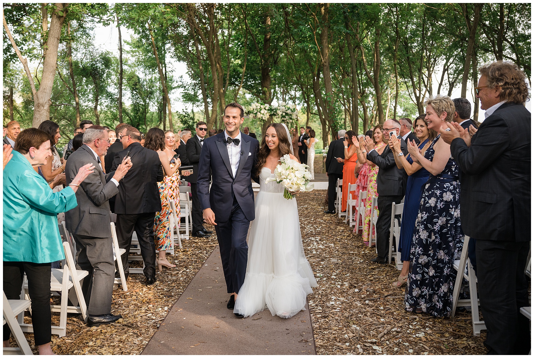 bride and groom walk down the aisle after wedding ceremony