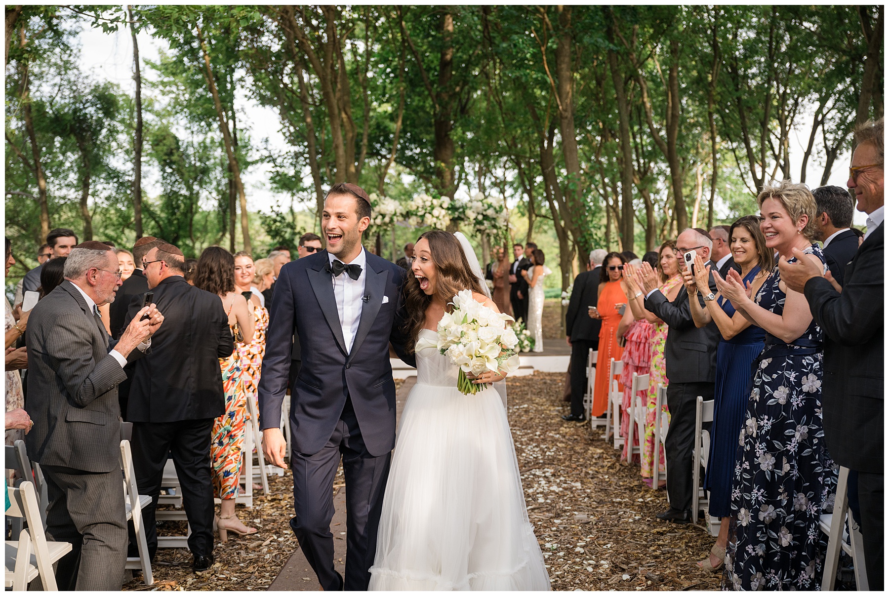 bride and groom walk down the aisle after wedding ceremony