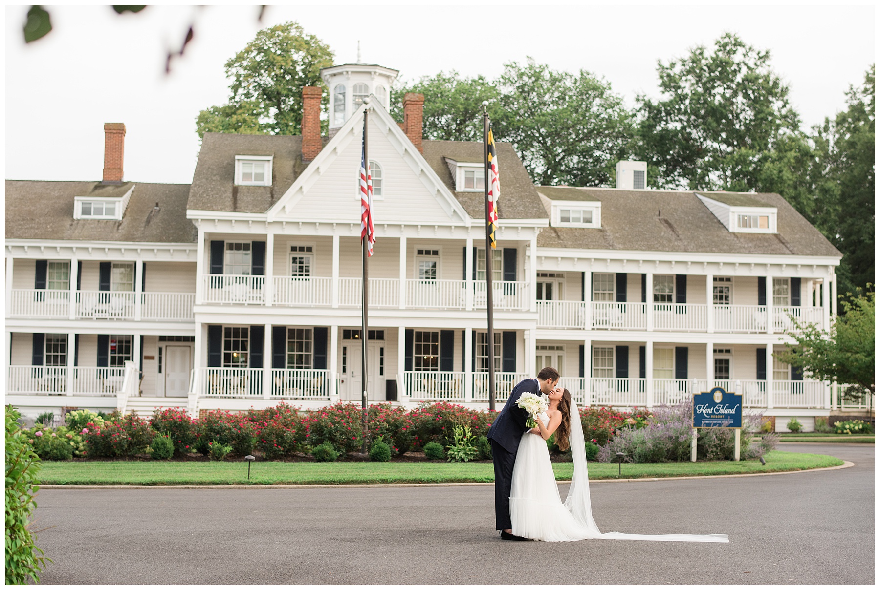 bride and groom kiss in front of kent island resort