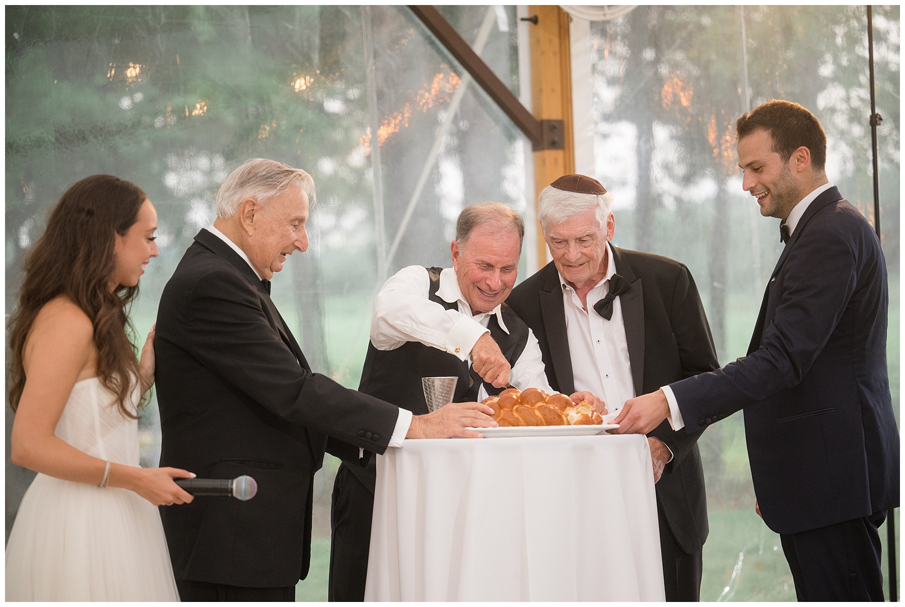 bride and groom serve challah at wedding