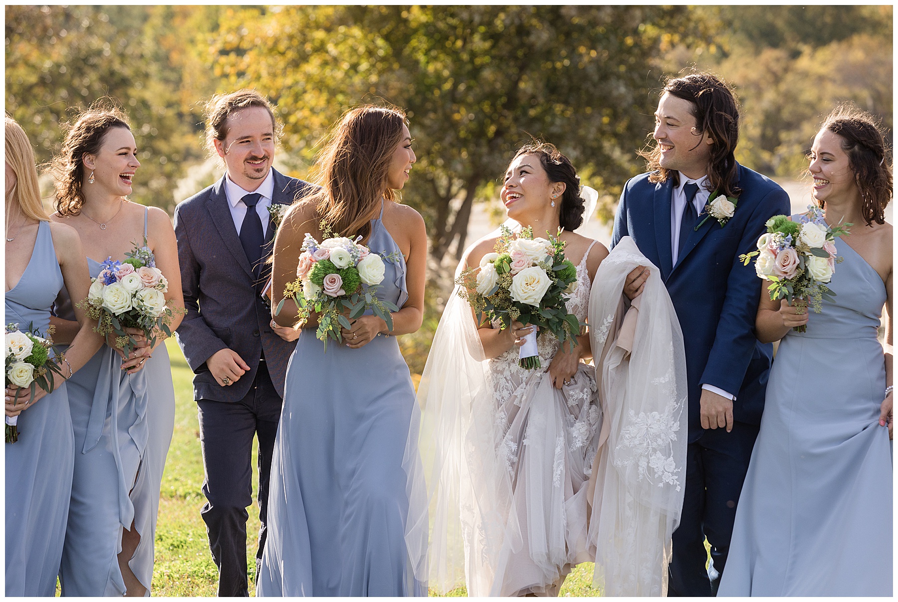 bride and groom walking with wedding party