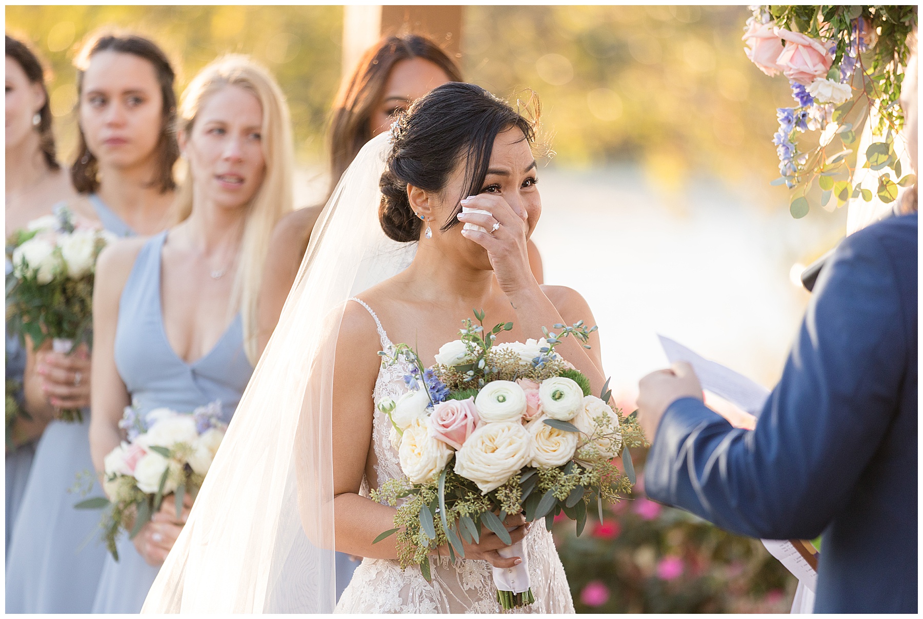 bride crying during wedding ceremony wiping tears