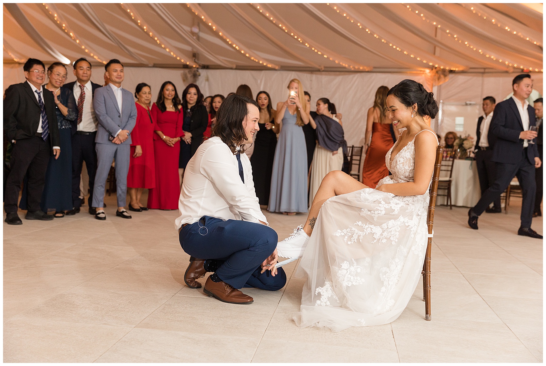 groom removing garter from bride