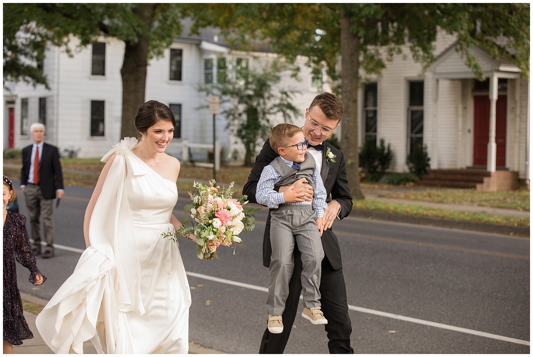 bride and groom leading guests to reception