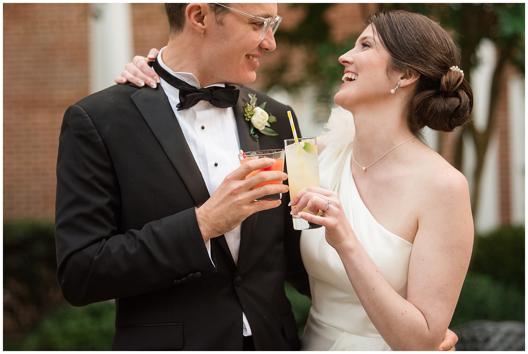 bride and groom cheering with signature cocktails