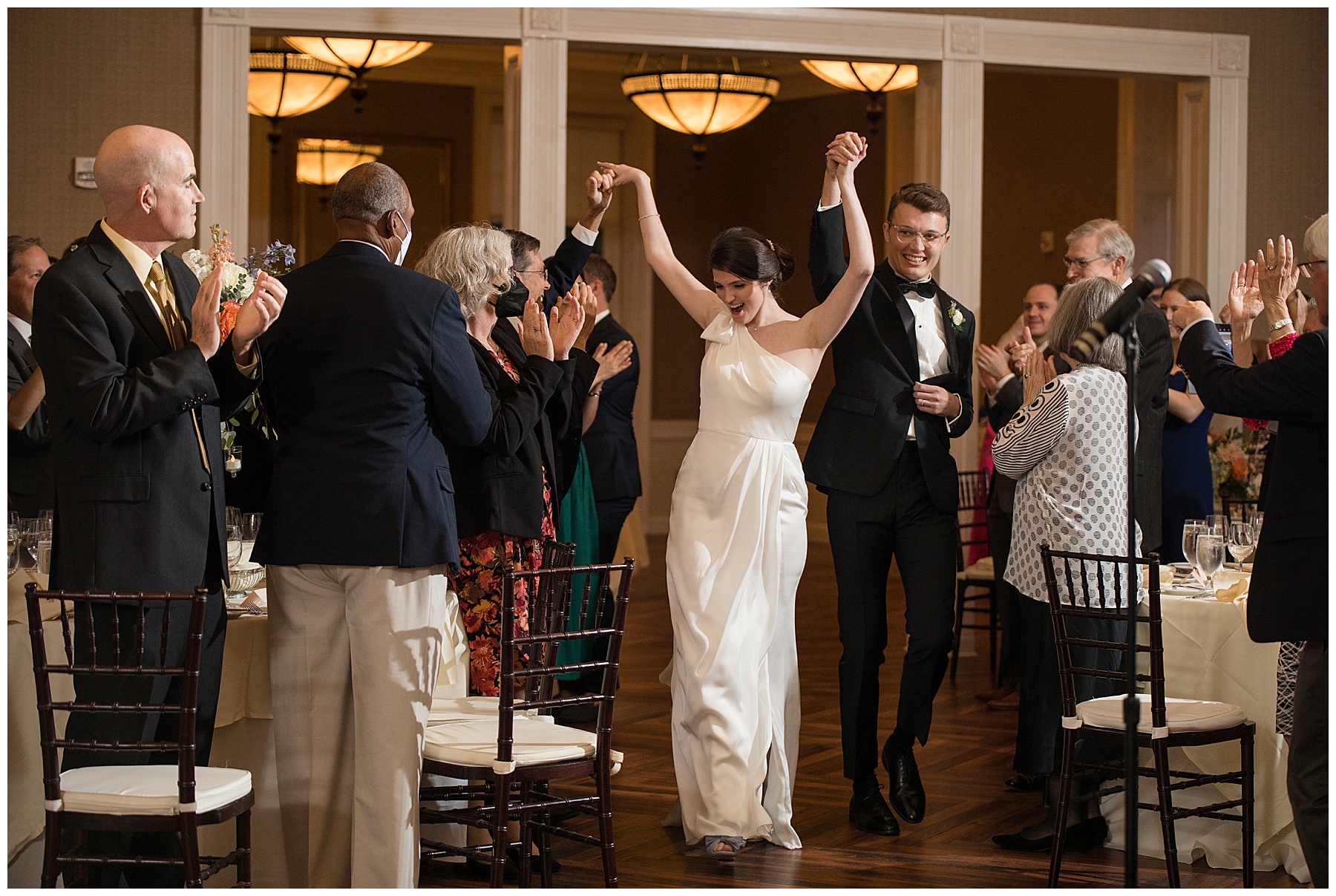 bride and groom enter wedding reception