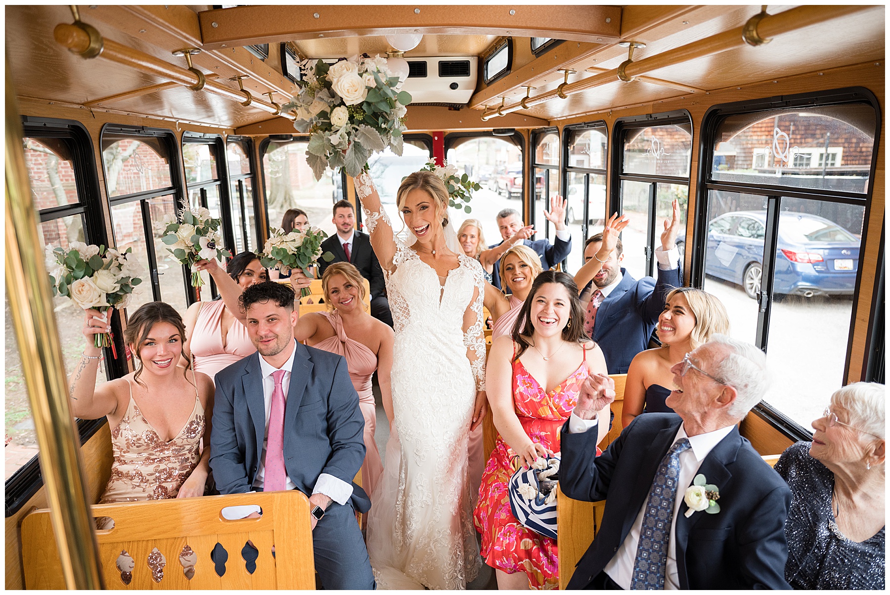 bride cheering with bouquet guests on annapolis trolley