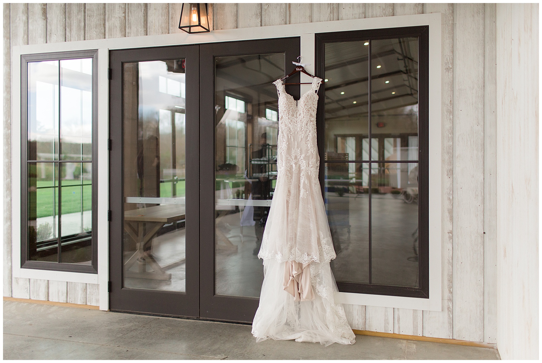 bride's dress hanging from farmstead