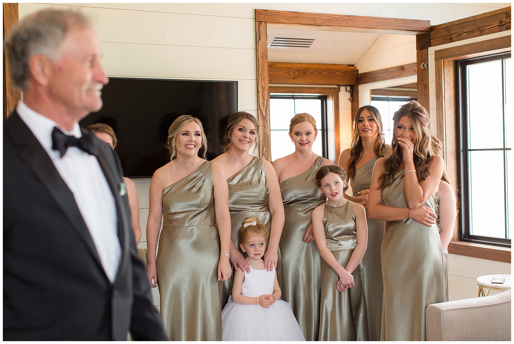 bridemaids looking lovingly at bride