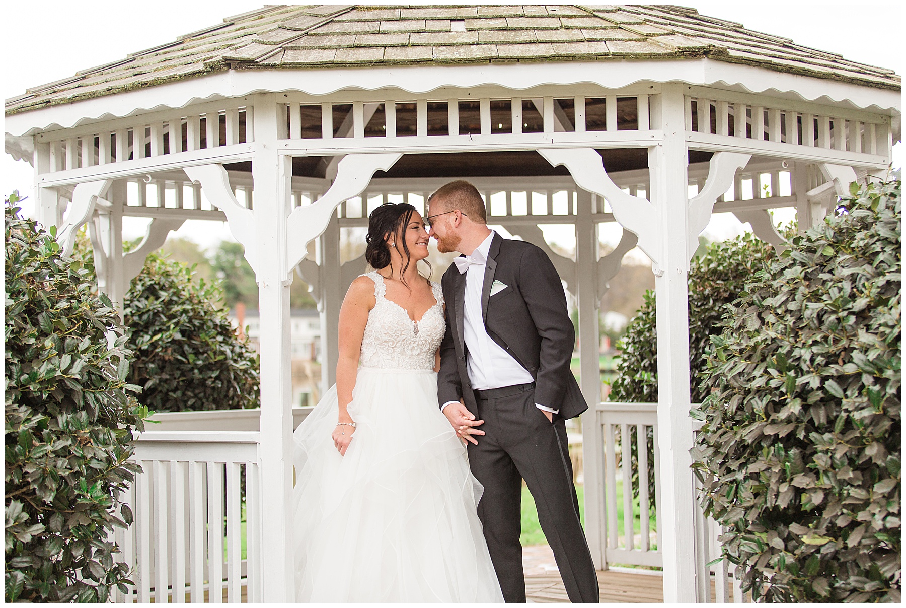 bride and groom embrace in gazebo