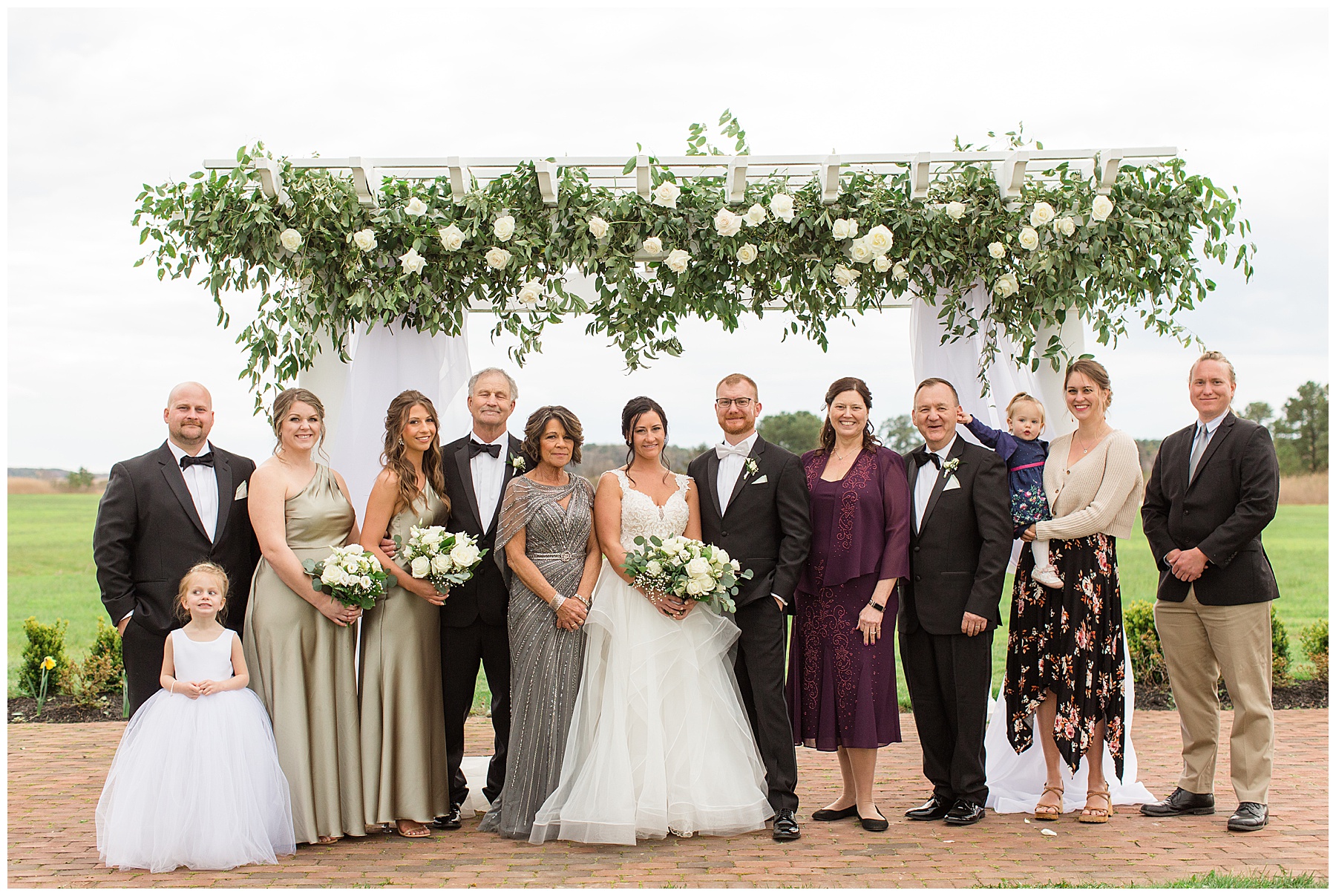 bride and family under arbor portrait